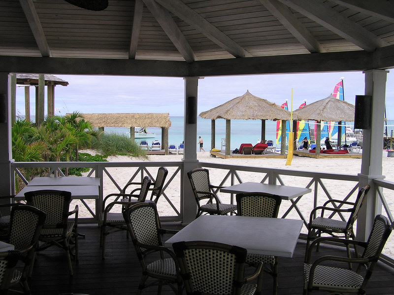View from Schooners restaurant onto the beach, where you can see Hobie cats and windsurfers available from the water-sports centre.  (152k)