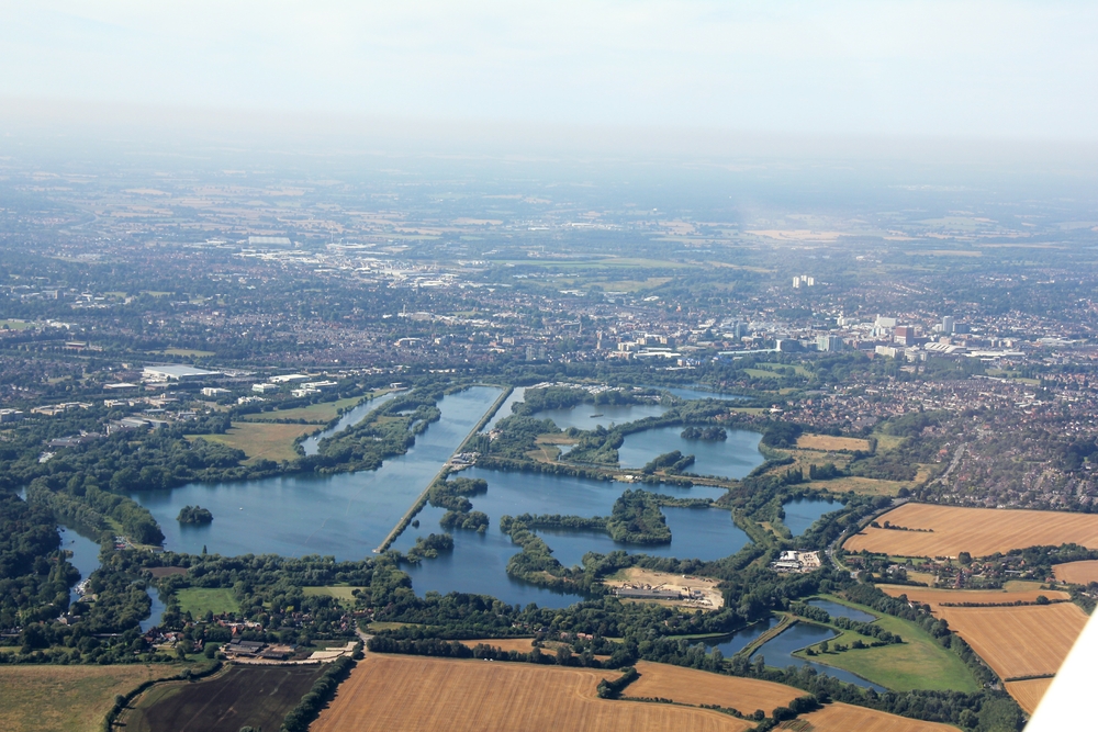 Shortly after take-off, Caversham Lakes, looking west, with Reading in the background. The long straight section is used by the 
					Redgrave Pinsent Rowing Lake..