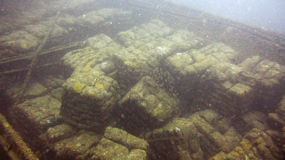 The strapped-together sacks of cement are clearly visible in the hold of the wreck.