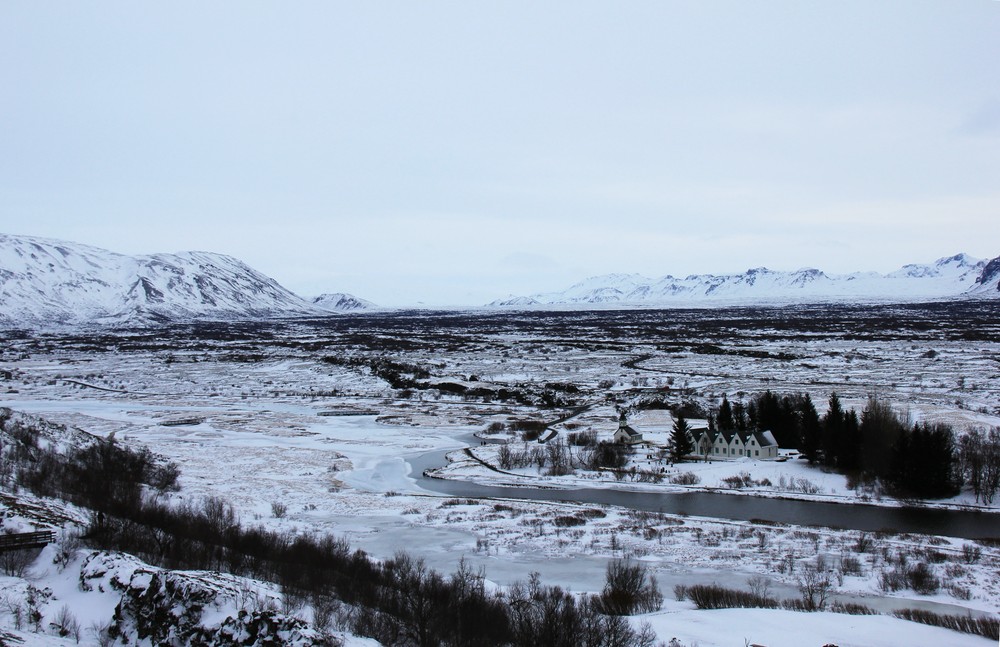Looking north up the Þingvellir rift valley. The mountains on the left are attached to the North American tectonic plate, while 
					those on the right are attached to the European plate. The plates are drawing apart at about 2cm per year, causing frequent 
					earthquakes and covering the floor of the valley with long cracks.