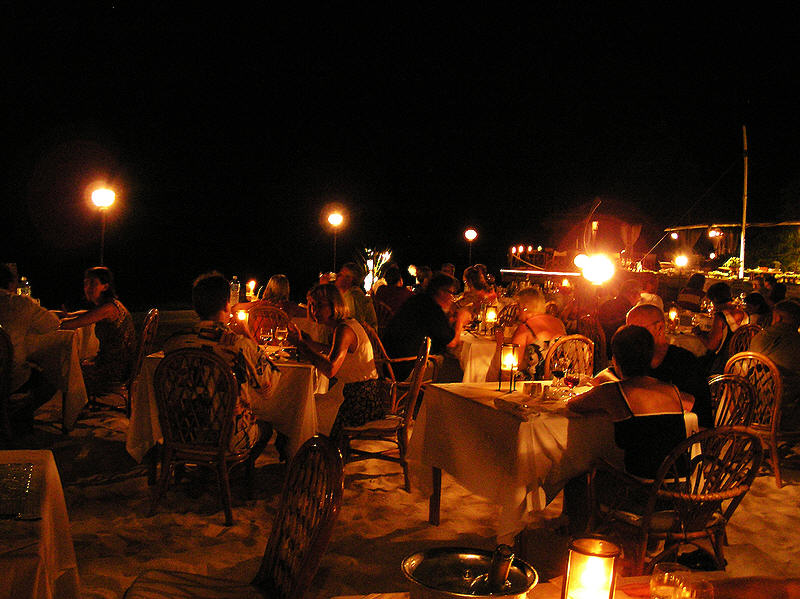One evening we all ate on tables set up on the beach under the stars.  (99k)