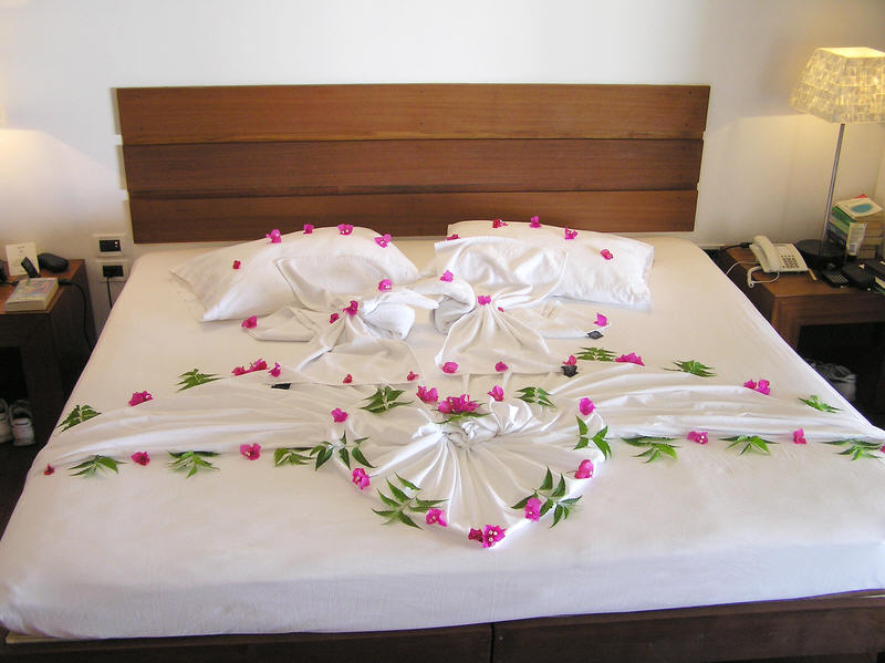 On your last night, you get your bed decorated with bougainvillea by your room boy.   (68k)