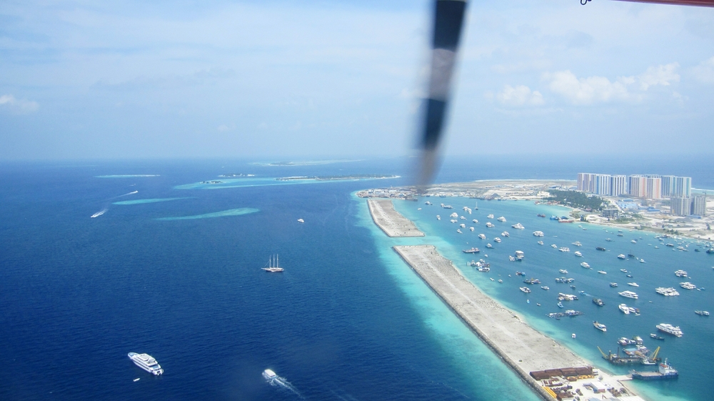 A few seconds after take-off.  The artificial island of Hulhumalé (right) just keeps getting larger. Compare this January 2020 photo 
            with the next one, which was taken from roughly the same place just two years earlier - note the dozen or so colourful tower blocks on the 
            right-hand edge of the photo.