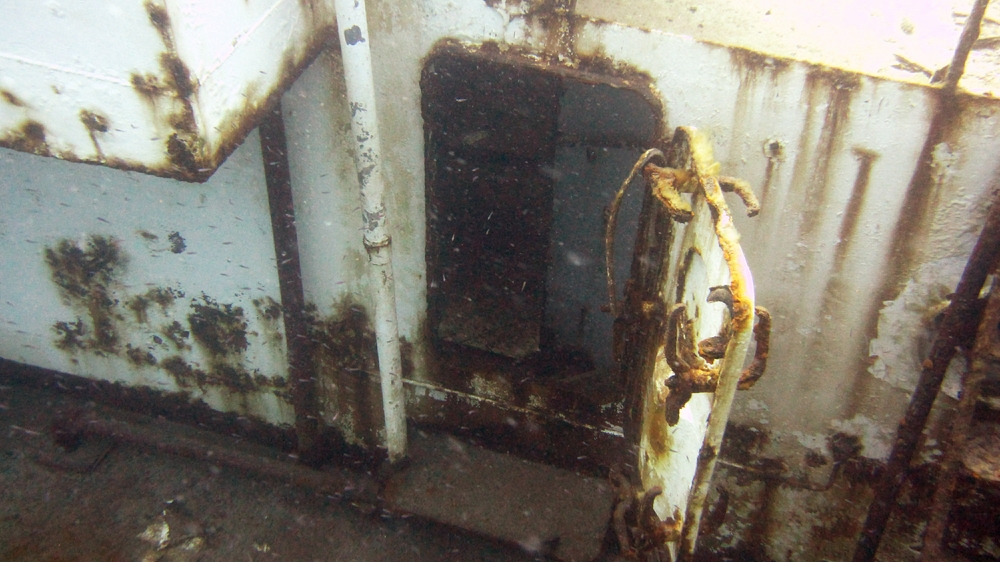 A rusting hatchway leading downstairs on the recently-sunk Vicki B.
