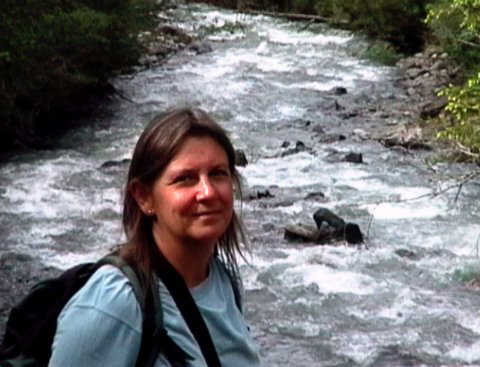 Civilised walking. Linda enjoying a stroll beside a glacial stream - she's carrying the picnic!