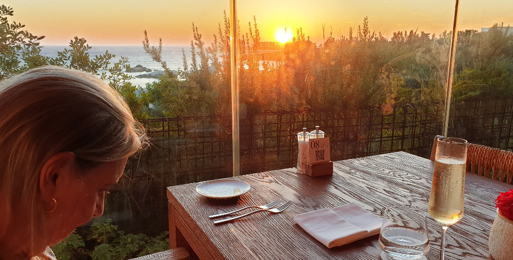 Linda studies the menu at Kohili restaurant as the sun sets.