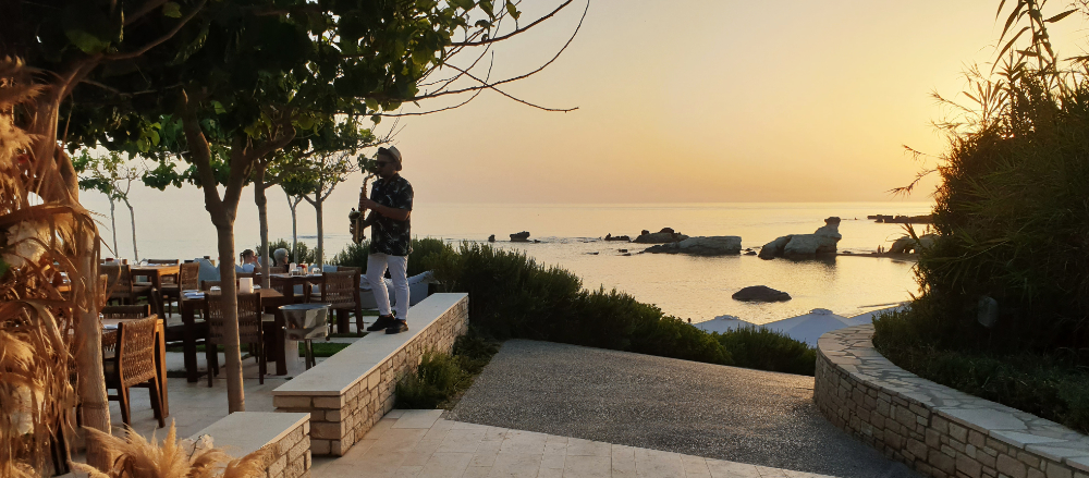 The saxophonist plays to the diners at Kohili restaurant as the sun sets.