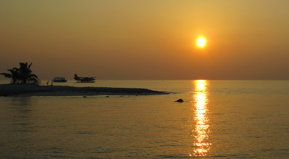 Sunset over Thudufushi's lagoon. Sometimes the seaplane is moored at the pontoon overnight, and the crew dine at Thudufushi.