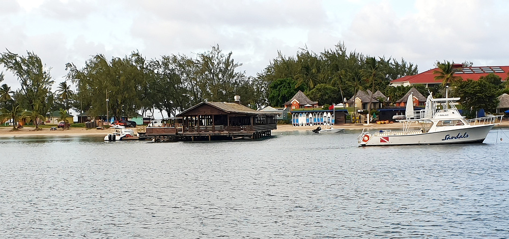 The wooden Gordon's-on-the-Pier restaurant at the left, with one of Sandals's dive boats moored on the right.